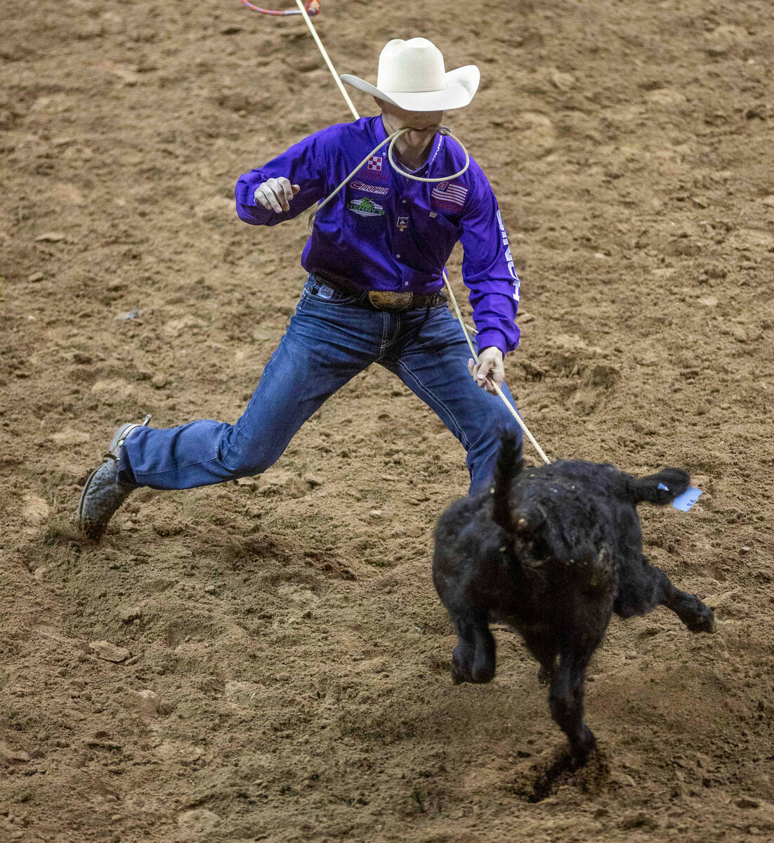Kincade Henry of Mount Pleasant, TX., approaches a calf as he competes during Tie-Down Roping i ...
