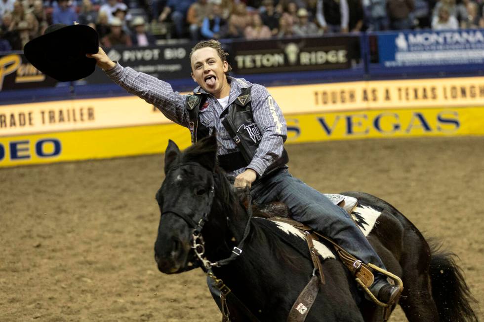 Logan Hay, of Wildwood, Alberta, Canada, celebrates after winning in the saddle bronc riding co ...