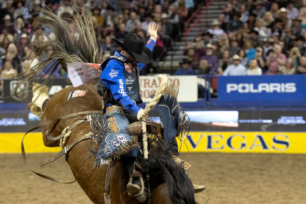 Ryder Wright, of Beaver, Utah, competes in saddle bronc riding during the sixth go-round of the ...