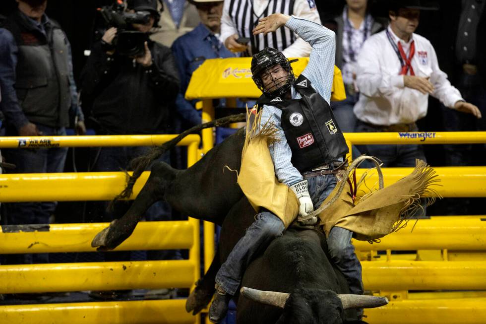 Garrett Smith, of Rexburg, Idaho, competes in bull riding during the sixth go-round of the Nati ...