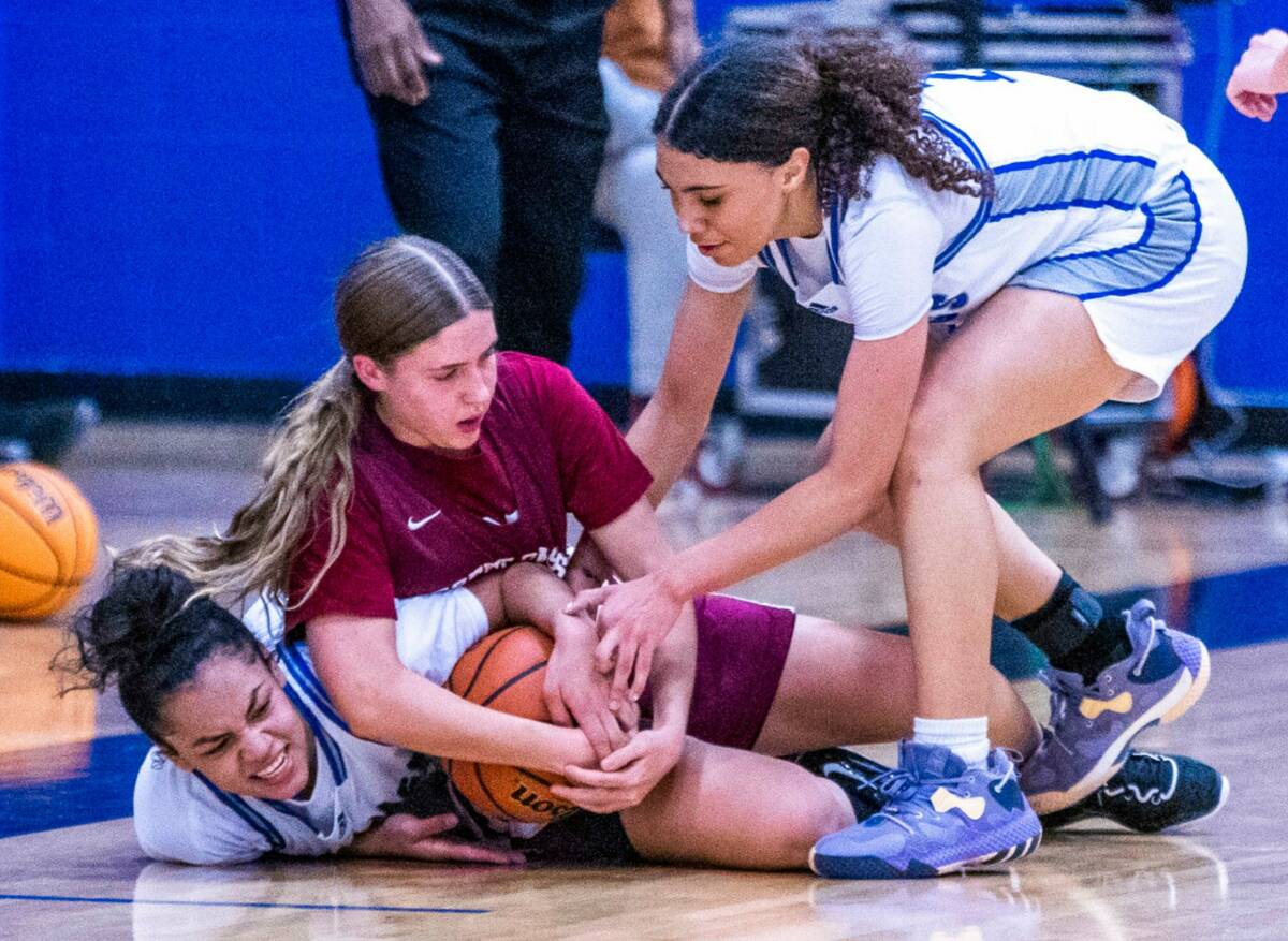 Desert Pines guard Mia Sao Martinez (1) and Desert Oasis (11) battle for a loose ball as Deser ...