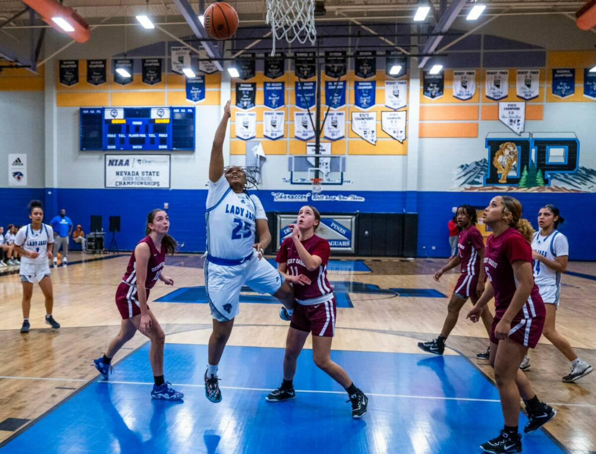 Desert Pines forward Ashanti Stewart (25) splits the Desert Oasis defense for a lay up during t ...