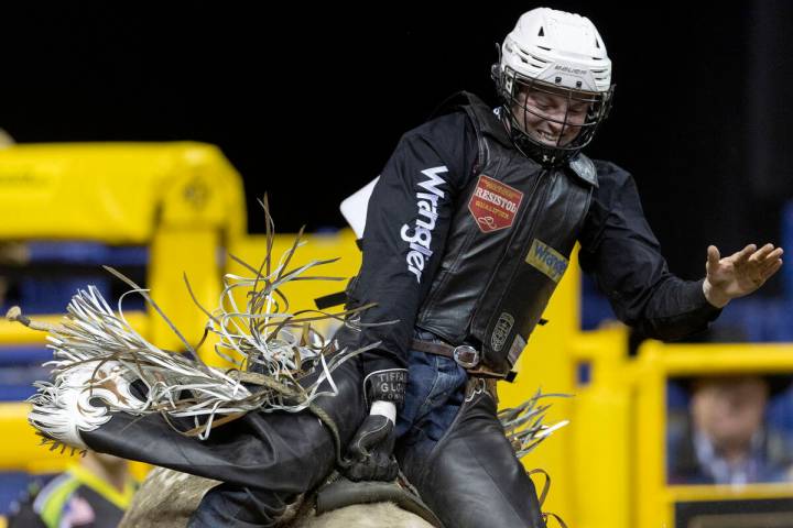 Ky Hamilton, of Mackay, Australia, smiles while competing in bull riding during the eighth go-r ...