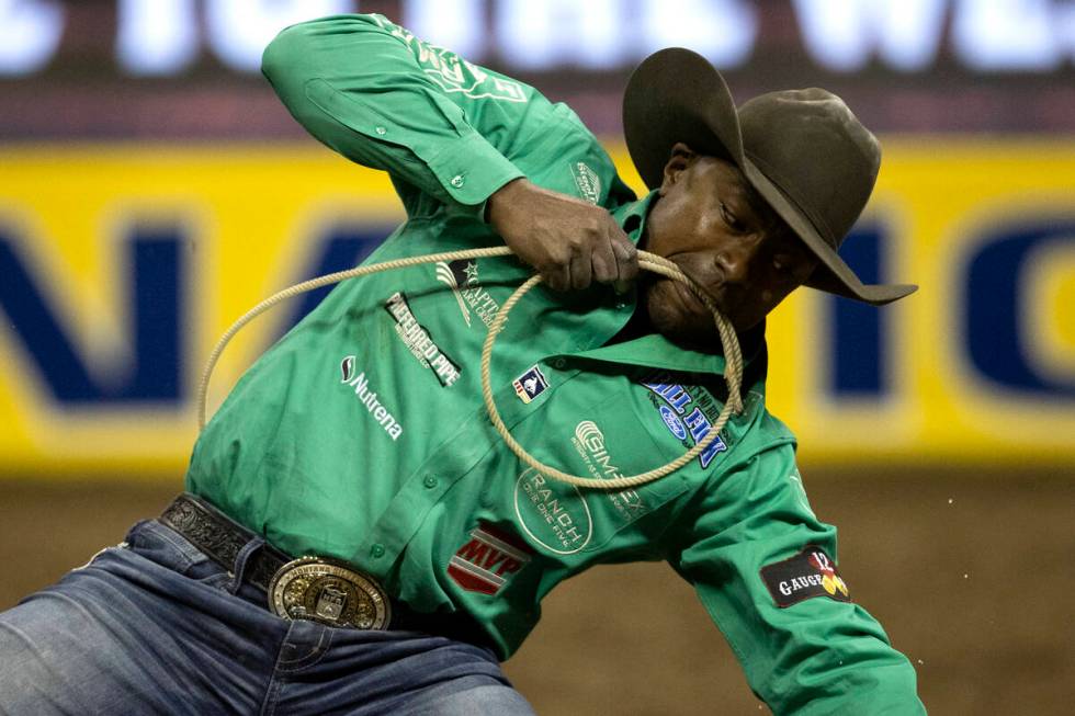 Cory Solomon, of Prairie View, Tex., competes in tie-down roping during the eighth go-round of ...