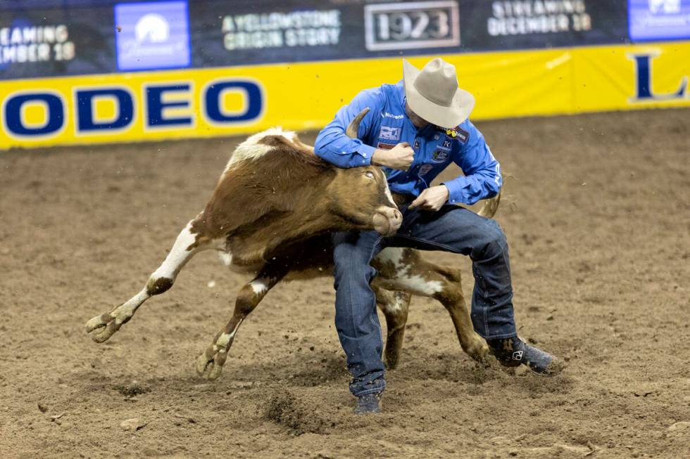 Tyler Waguespack, of Gonzales, La., competes in steer wrestling during the eighth go-round of t ...