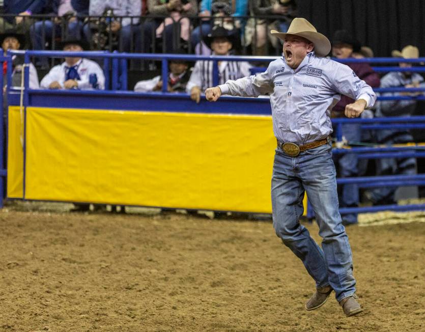 Hunter Cure of Holliday, Texas, celebrates a winning time in Steer Wrestling during the Nationa ...