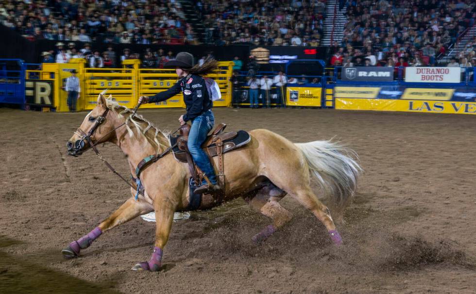 Hailey Kinsel of Cotulla, Texas, navigates a barrel on the way to her winning time in Barrel Ra ...