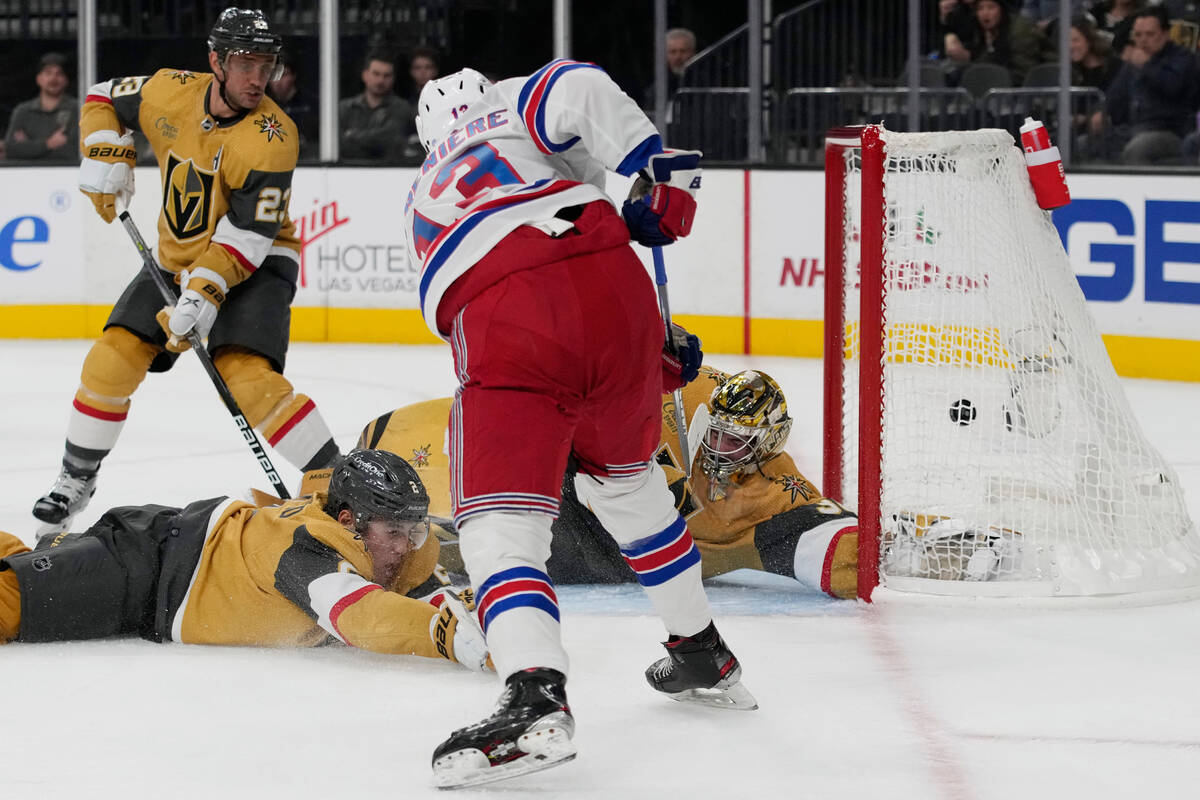 New York Rangers left wing Alexis Lafrenière (13) scores on Vegas Golden Knights goaltende ...