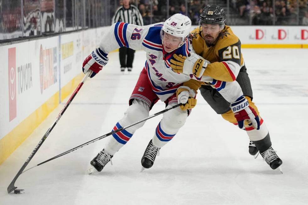 New York Rangers left wing Jimmy Vesey (26) skates around Vegas Golden Knights center Chandler ...