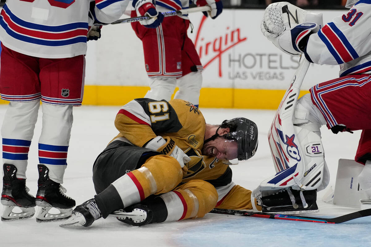 Vegas Golden Knights right wing Mark Stone (61) writhes on the ice after a play against the New ...