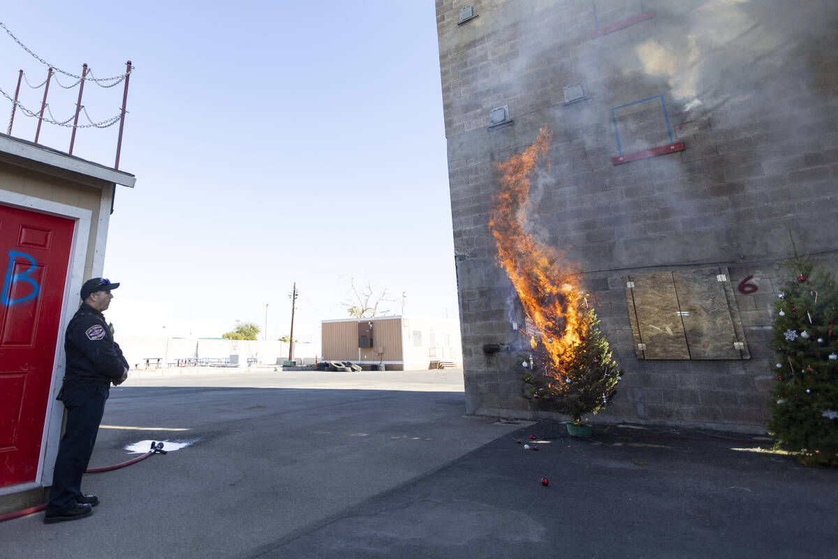 A Christmas tree burns as part of a demonstration on the potential fire dangers of Christmas tr ...