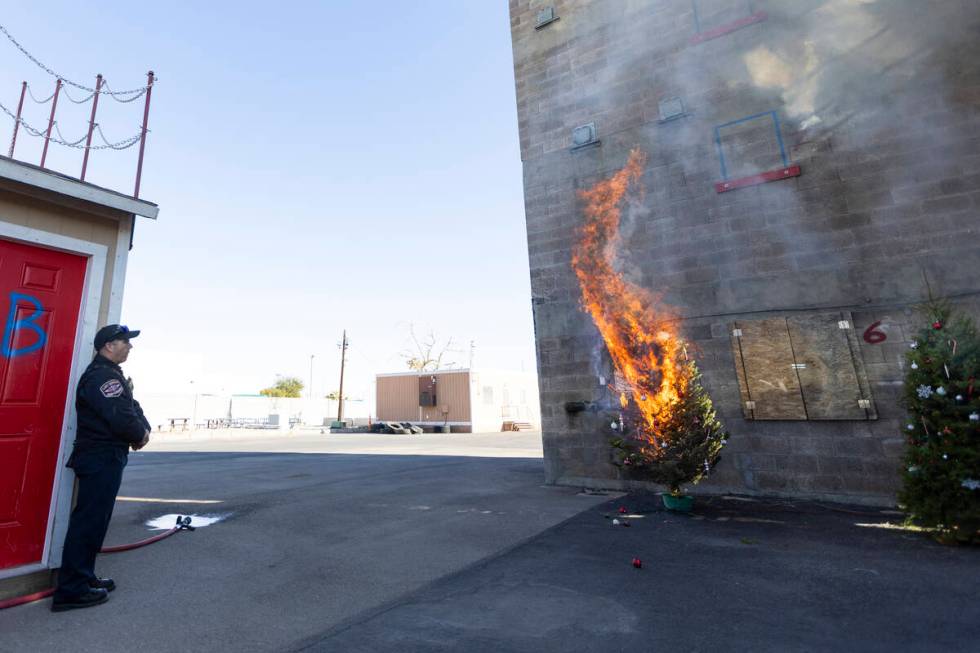 A Christmas tree burns as part of a demonstration on the potential fire dangers of Christmas tr ...