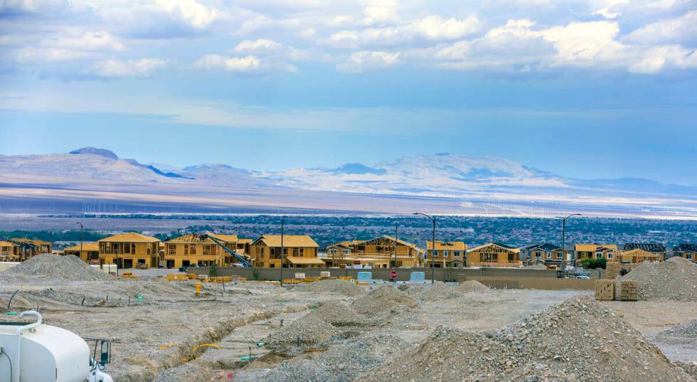 Workers complete framing and walls on new home construction about Skye Canyon on Wednesday, Jul ...