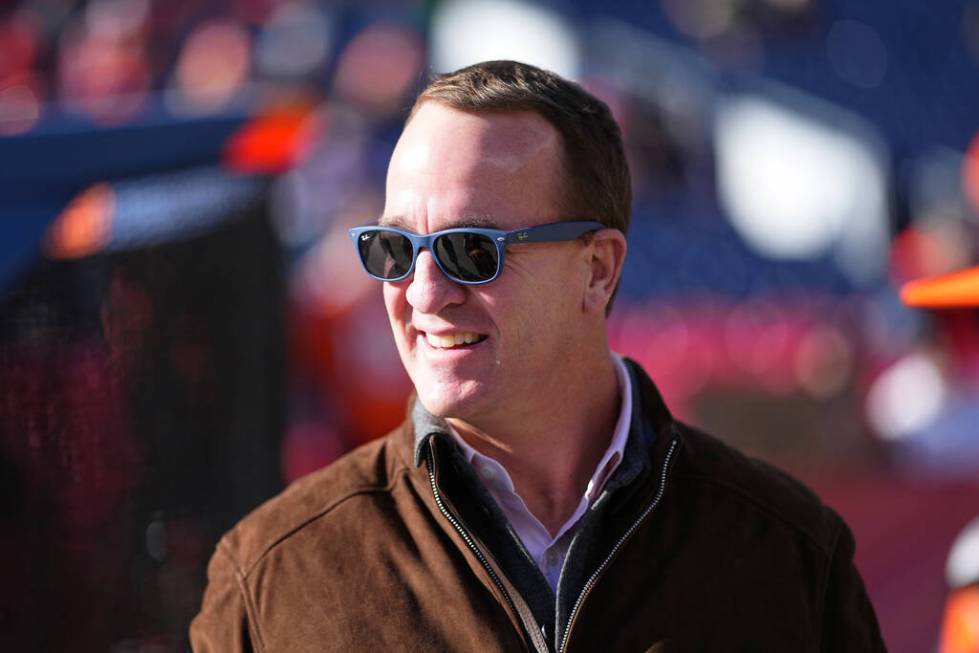 Former quarterback Peyton Manning watches players warm up before an NFL football game between t ...