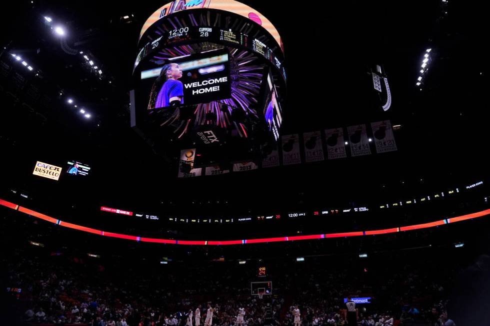 Brittney Griner is welcomed home on a large screen during the first half of an NBA basketball g ...