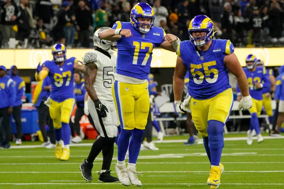 Los Angeles Rams quarterback Baker Mayfield (17) celebrates a touchdown by wide receiver Van Je ...