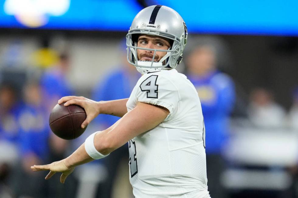 Las Vegas Raiders quarterback Derek Carr warms up before an NFL football game against the Los A ...