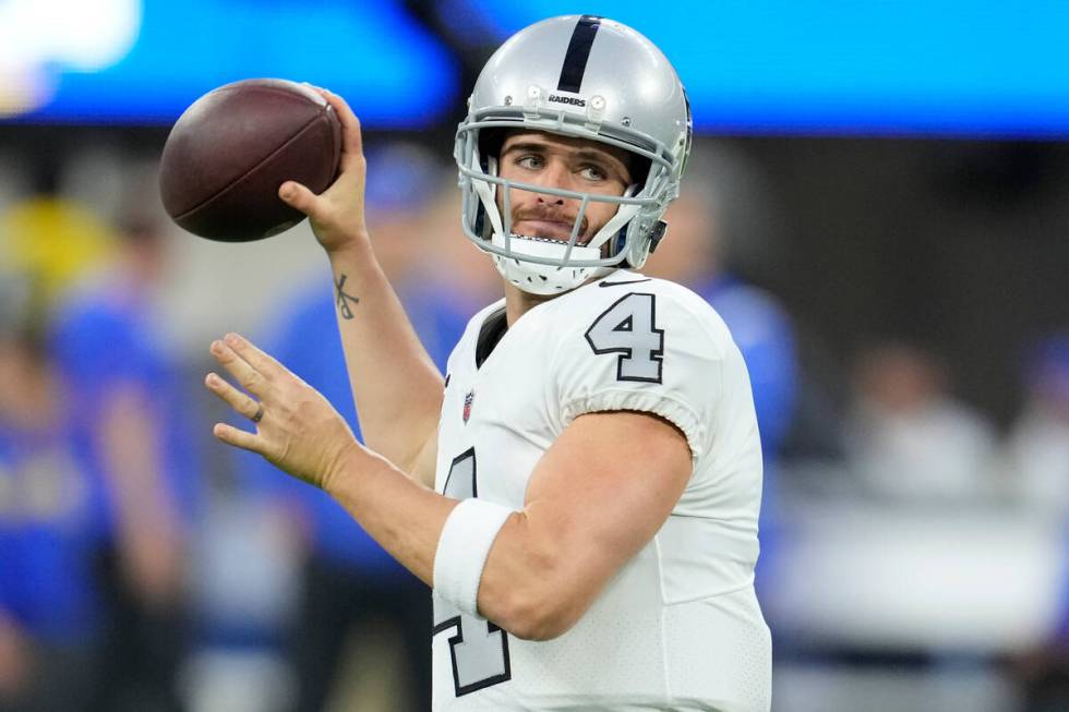 Las Vegas Raiders quarterback Derek Carr warms up before an NFL football game against the Los A ...