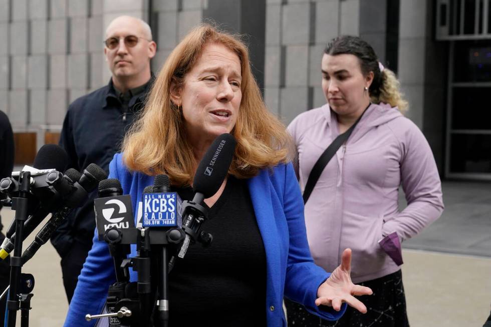 Attorney Shannon Liss-Riordan, foreground, speaks in front of former Twitter employees Dmitry B ...