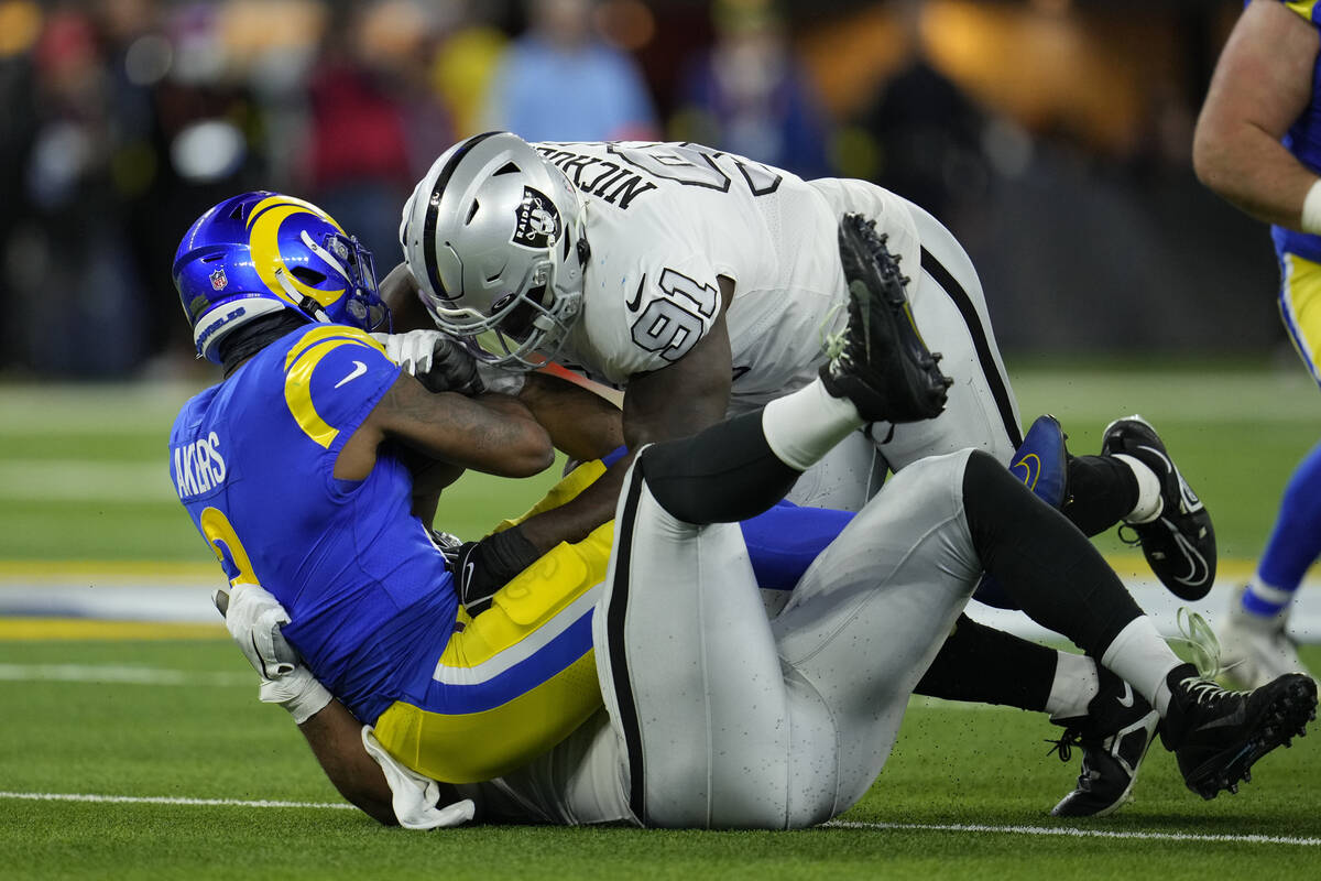 Las Vegas Raiders defensive tackle Bilal Nichols stops running back Cam Akers during the first ...