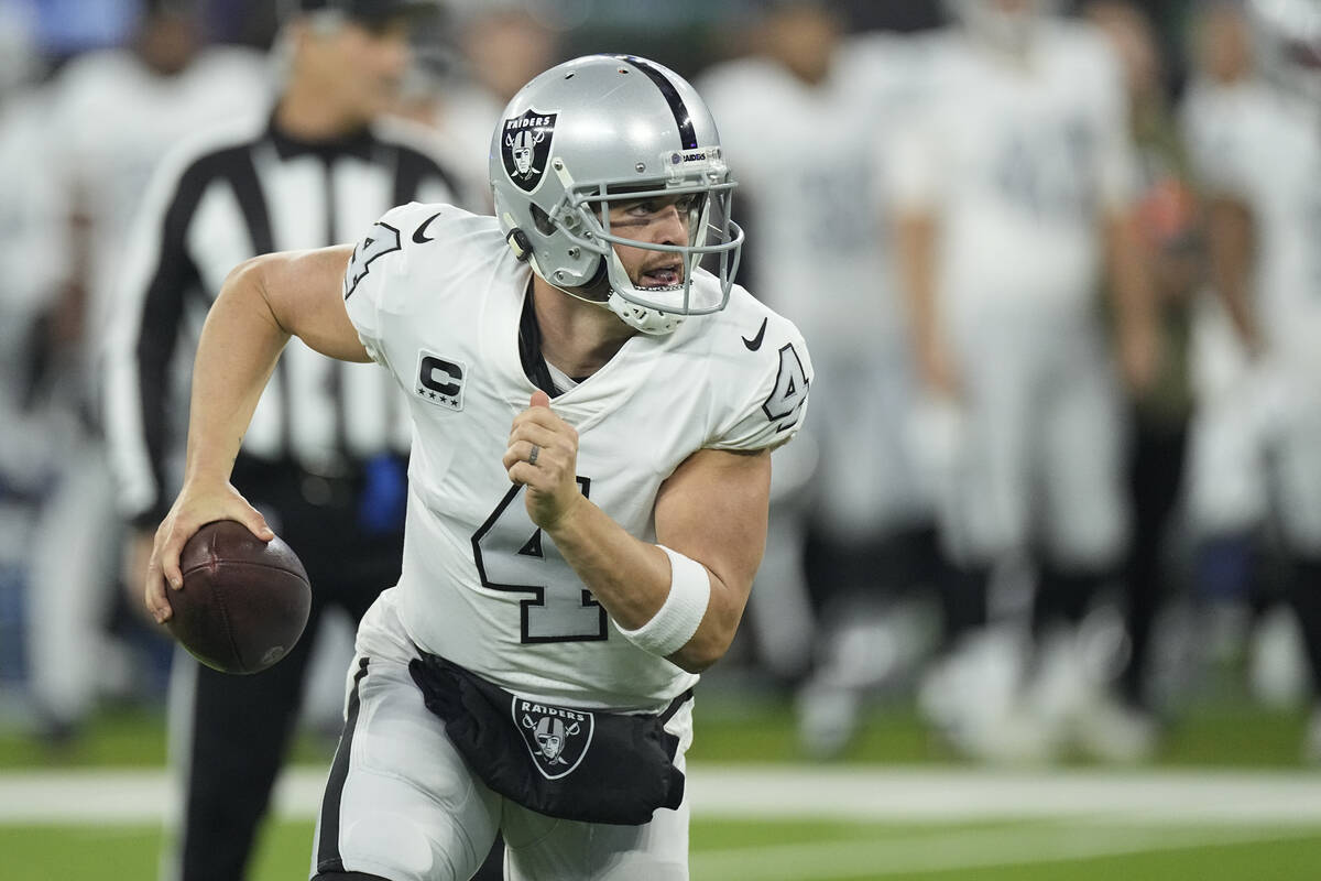 Las Vegas Raiders quarterback Derek Carr scrambles during the first half of an NFL football gam ...