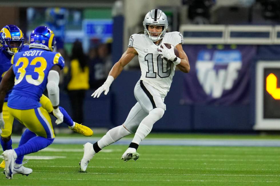 Las Vegas Raiders wide receiver Mack Hollins runs with the ball during the first half of an NFL ...