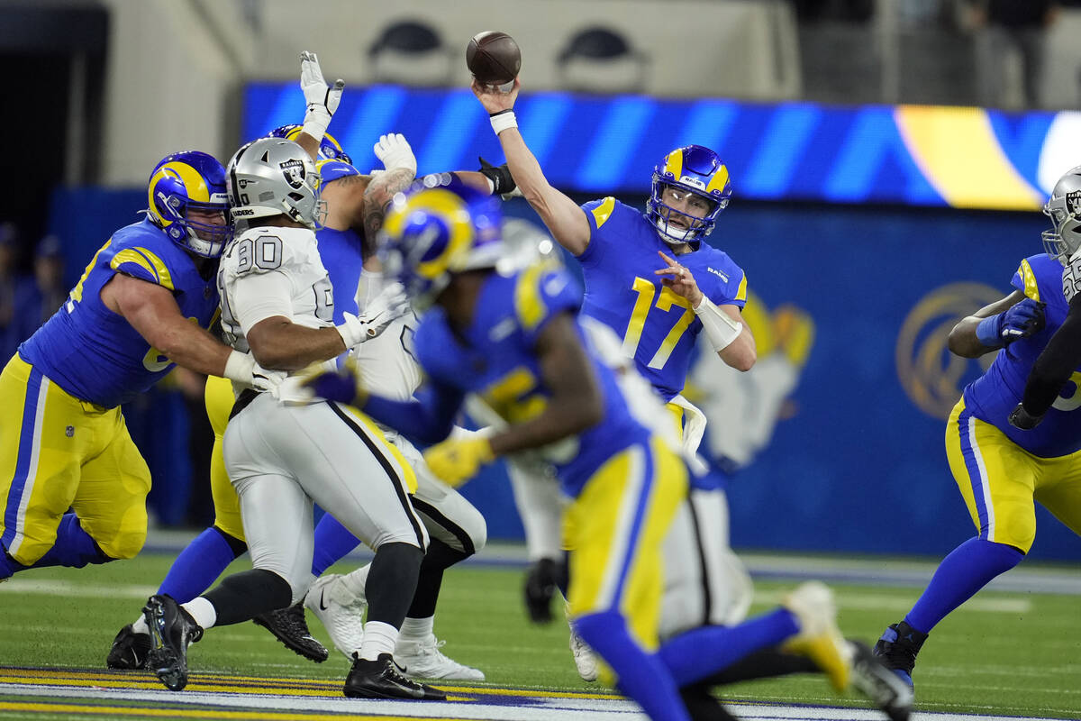 Los Angeles Rams quarterback Baker Mayfield throws a pass during the first half of an NFL footb ...