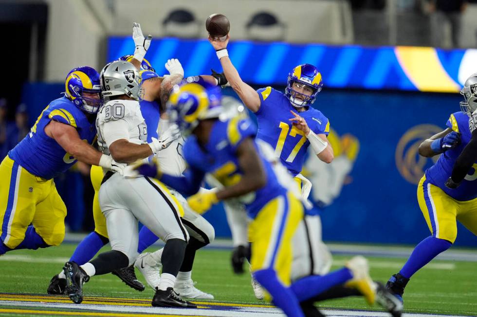 Los Angeles Rams quarterback Baker Mayfield throws a pass during the first half of an NFL footb ...