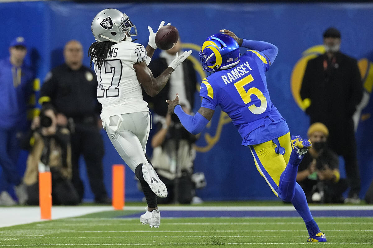 Las Vegas Raiders wide receiver Davante Adams, left, makes a catch as Los Angeles Rams cornerba ...