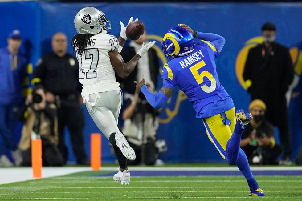 Las Vegas Raiders wide receiver Davante Adams, left, makes a catch as Los Angeles Rams cornerba ...