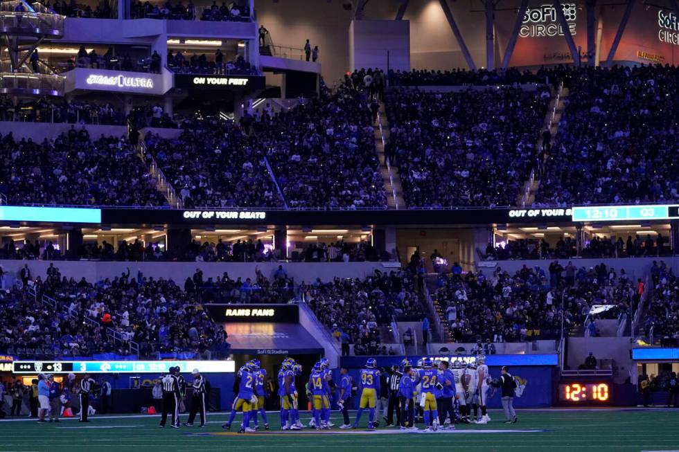 Fans hold lights from their phones during the second half of an NFL football game between the L ...