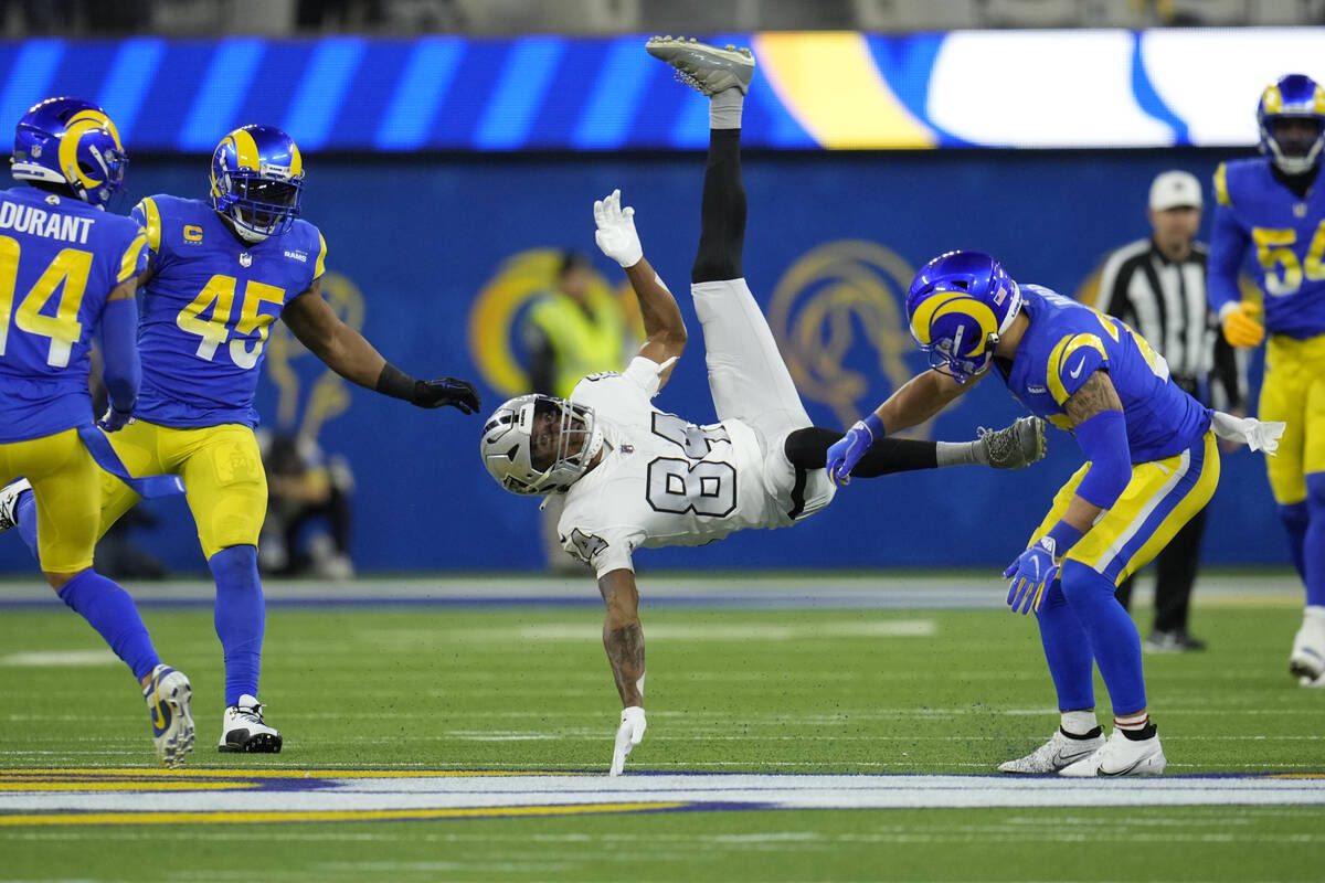 Las Vegas Raiders wide receiver Keelan Cole (84) is hauled down by Los Angeles Rams safety Tayl ...