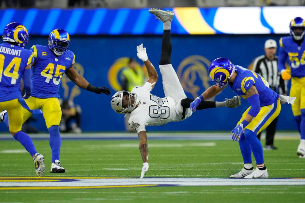 Las Vegas Raiders wide receiver Keelan Cole (84) is hauled down by Los Angeles Rams safety Tayl ...