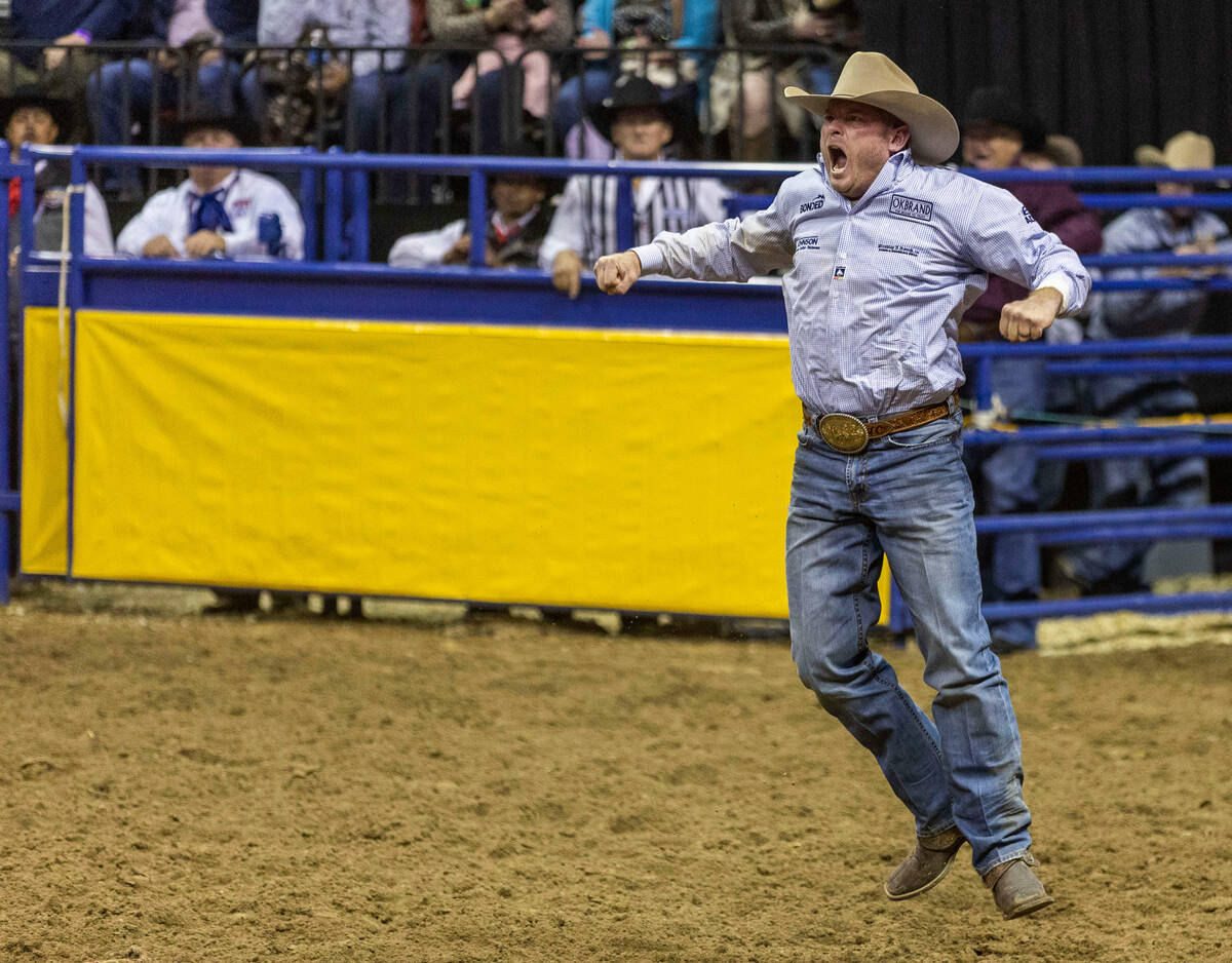 Hunter Cure of Holliday, Texas., celebrates a winning time in Steer Wrestling during the Nation ...