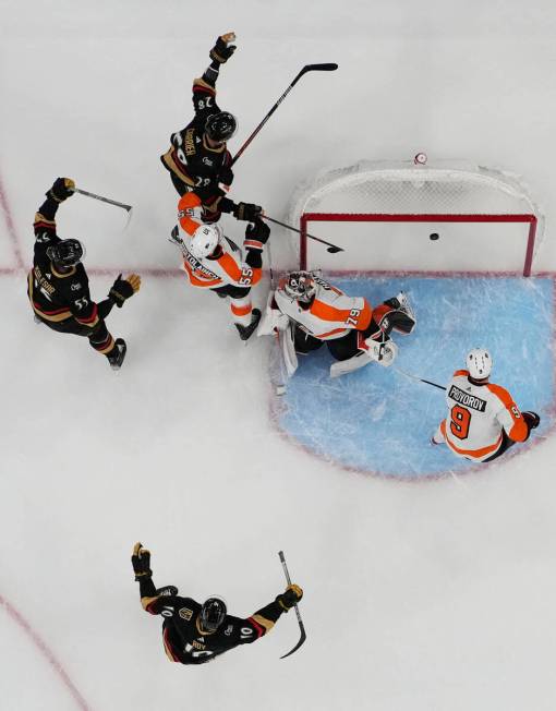 Vegas Golden Knights left wing William Carrier, top, celebrates after scoring against the Phila ...