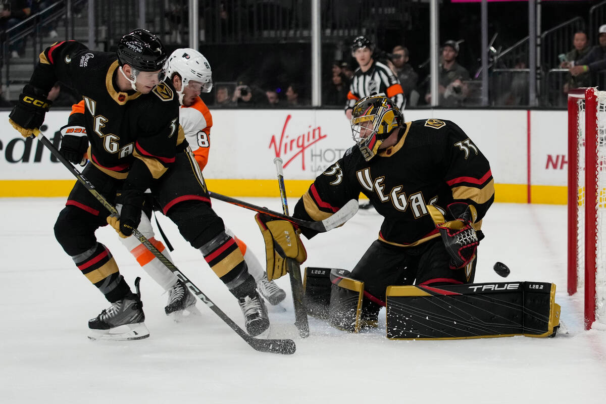 Vegas Golden Knights goaltender Adin Hill (33) stops a shot beside Vegas Golden Knights defense ...