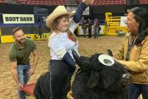 Hannah Huse is all smiles aboard the seesaw bull at Thursday morning's Exceptional Rodeo, held ...