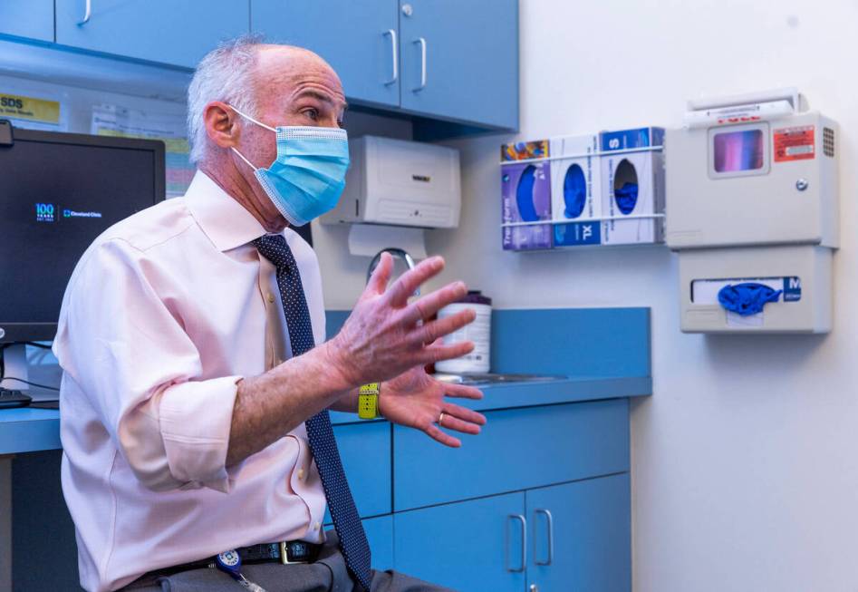 Dr. Charles Bernick talks with clinical trial participant Bob Lathrop before he receives his ne ...