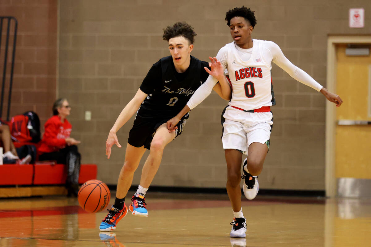 Shadow Ridge's Dylan Pullen (0) defends the ball from Arbor View's Demarion Yap during a boy's ...