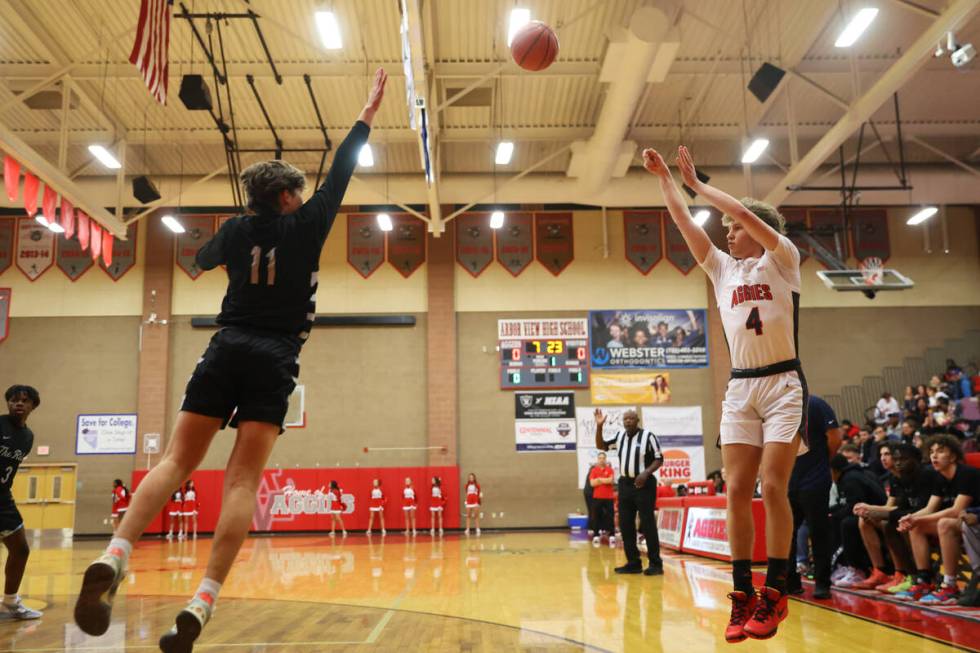 Arbor View's Jalen Dickel (4) takes a shot under pressure from Shadow Ridge's Brock Morrow (11) ...