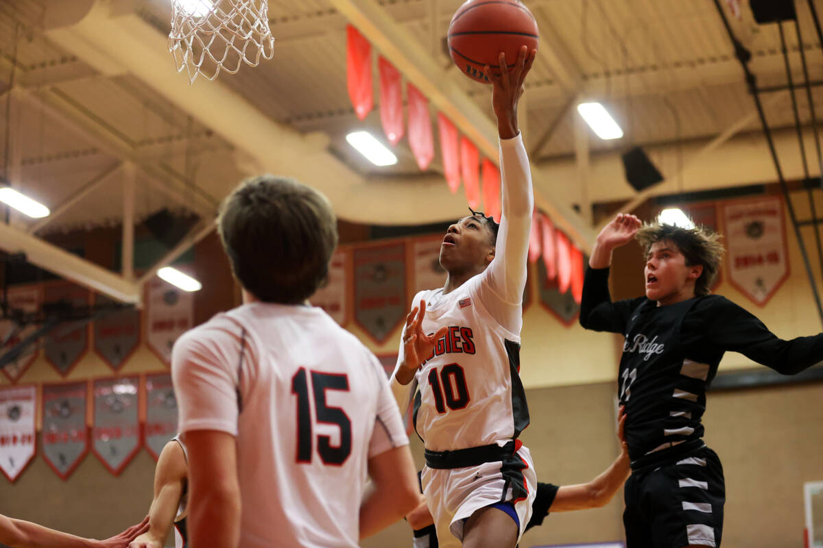 Arbor View's Tremmell Darden (10) takes a shot under pressure from Shadow Ridge's Brock Morrow ...