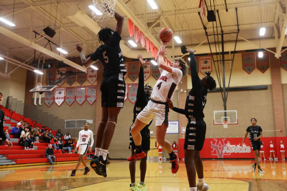 Arbor View's Jalen Dickel (4) takes a shot under pressure from Shadow Ridge's Ron Flenoy (5) du ...