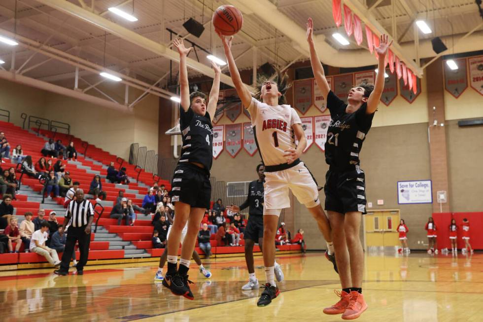 Arbor View's Maximus Romero (1) takes a shot under pressure from Shadow Ridge's Liam Guthrie (4 ...