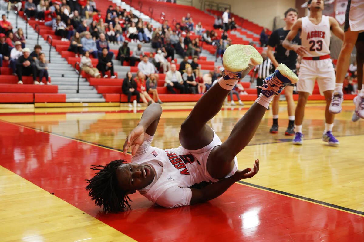 Arbor View's Bryce Heckard (5) takes a fall after a play against Shadow Ridge during a boy's b ...