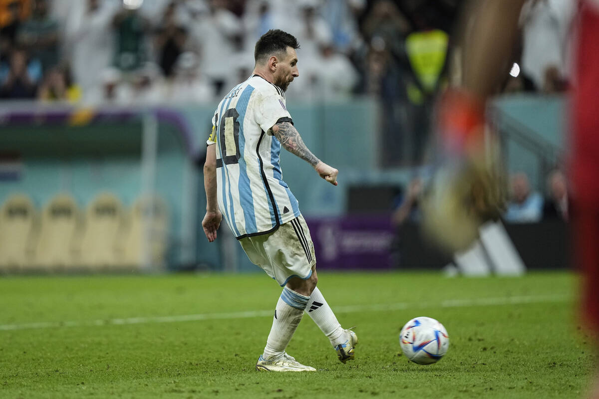 Argentina's Lionel Messi scores a penalty kick during the World Cup quarterfinal soccer match b ...