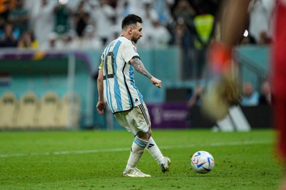 Argentina's Lionel Messi scores a penalty kick during the World Cup quarterfinal soccer match b ...