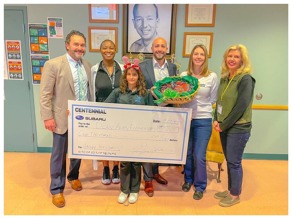 Centennial Subaru General Manager Ryon Walters, from left, Principal Juanita Booker Fraiser, Le ...