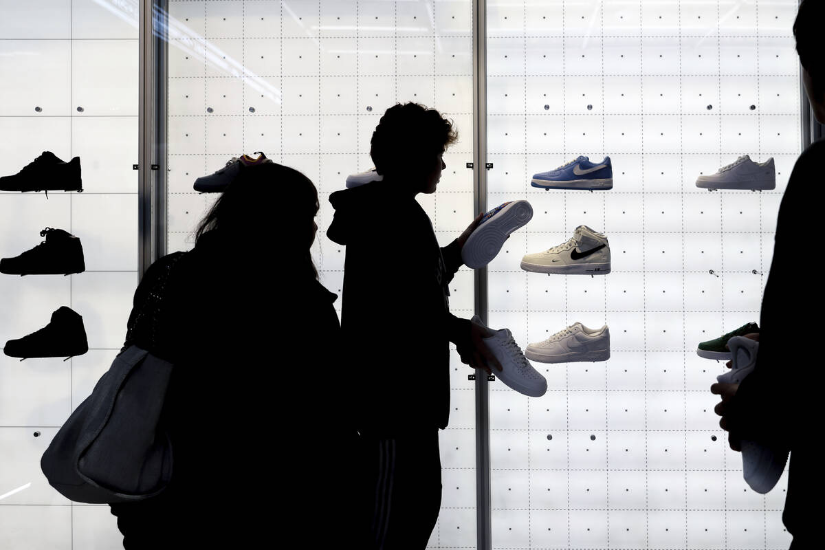 FILE - People shop for shoes in a Nike store on Black Friday, Nov. 25, 2022, in New York. On Tu ...