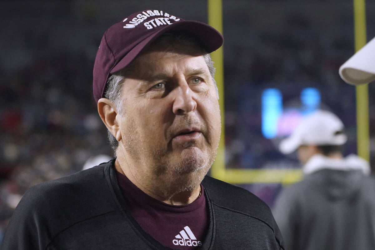 Mississippi State coach Mike Leach talks with Mississippi coach Lane Kiffin before an NCAA coll ...