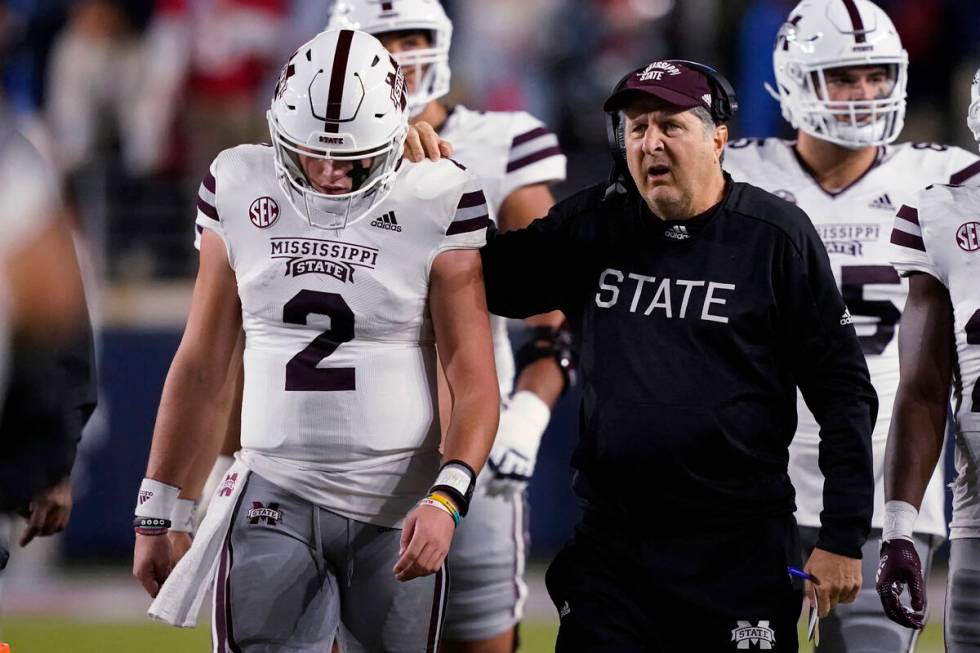 Mississippi State coach Mike Leach confers with quarterback Will Rogers (2) during the first ha ...